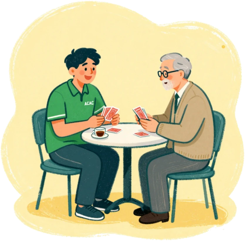 A warm companion sitting with an older person over a cup of tea and cards